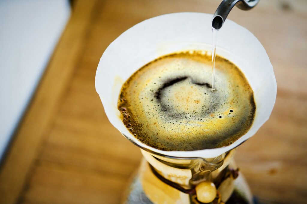 Water poured through a paper filter into a Chemex
