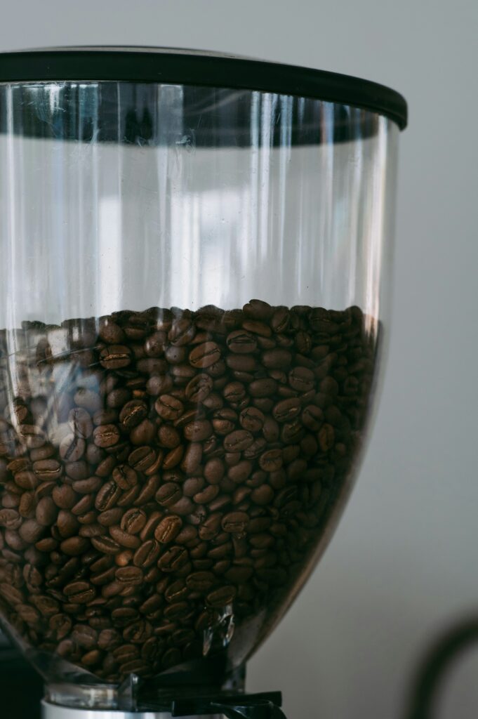 A coffee grinder filled with whole coffee beans