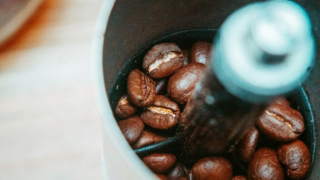 A coffee grinder with coffee beans in its hopper